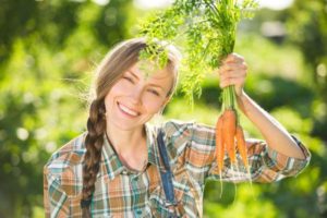 gardener holding carrots